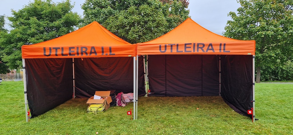 A two orange tents with black cover
Description automatically generated